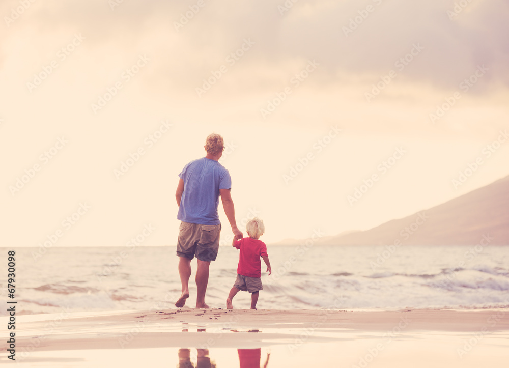 Father and son wallking on the beach