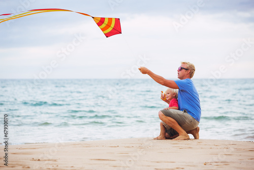 Father and son playing with kite