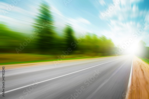 Asphalt road in motion blur on summer day.
