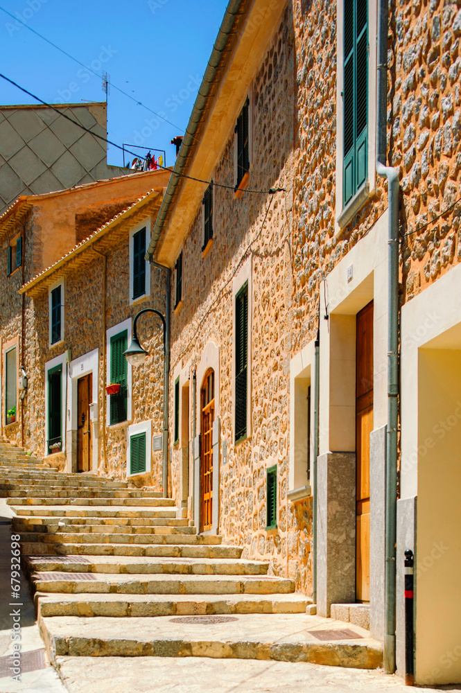 Colorful street in mediterranean village with cobblestone