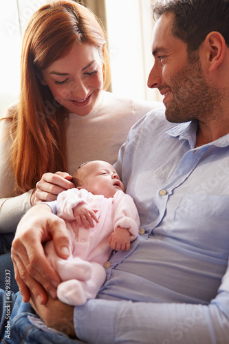 Mother And Father At Home With Newborn Baby