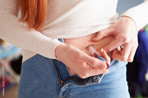 Female Diabetic Injecting Themselves With Insulin photo