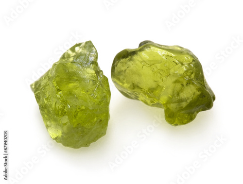 Fotografie Green peridot raw gemstones on the white background.