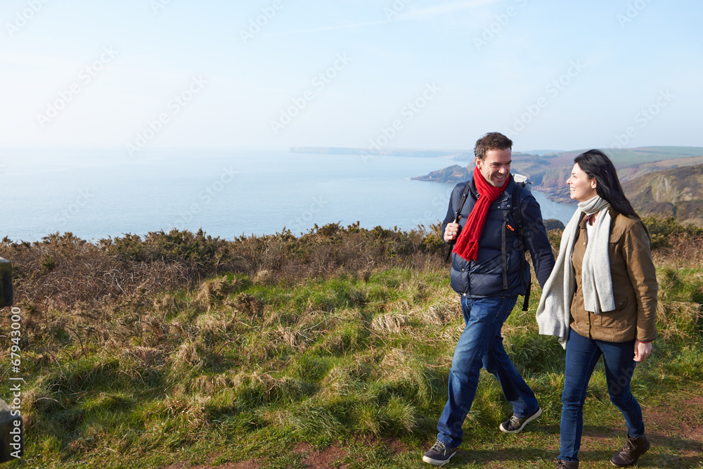 Couple Walking Along Coastal Path
