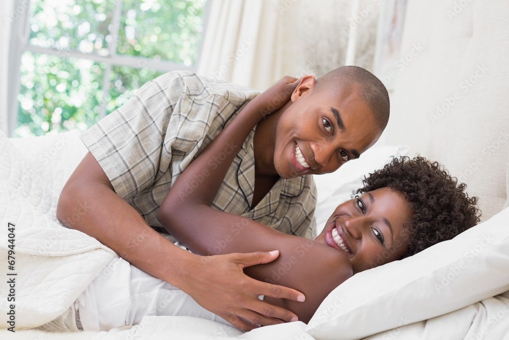 Intimate couple cuddling lying on their bed Intimate couple cuddling lying on their bed