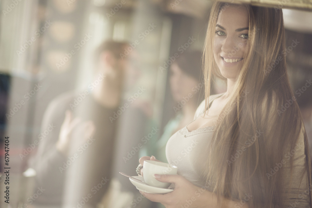 Beautiful young woman with coffee cup