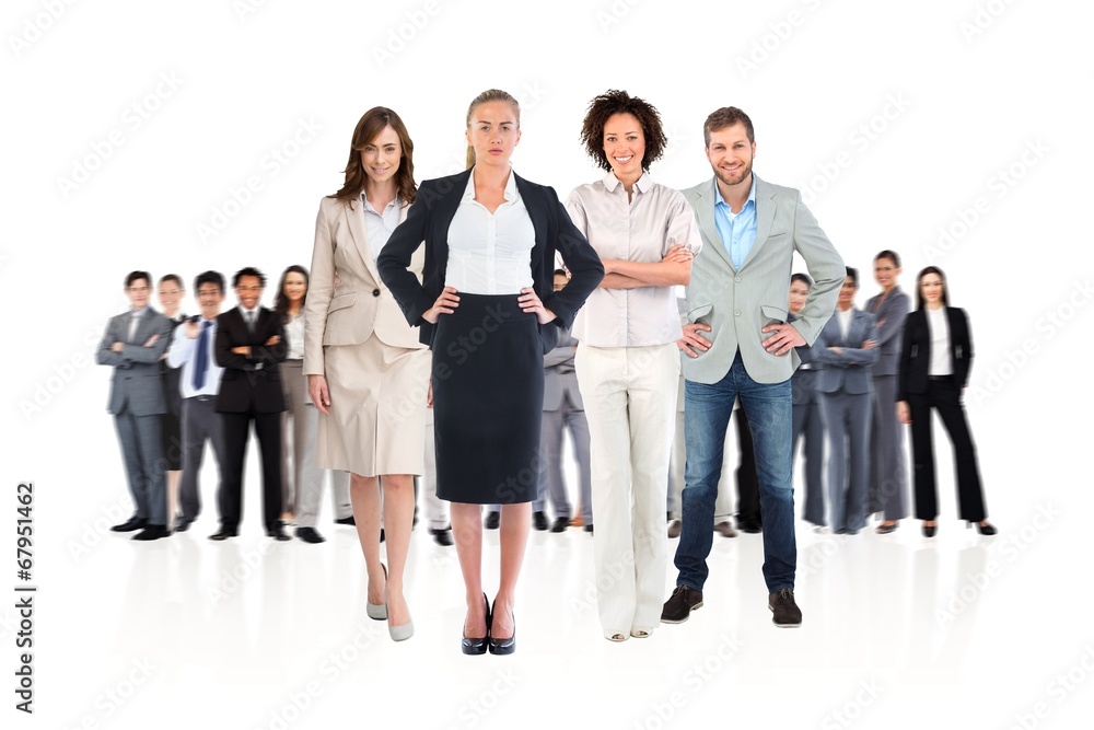 Composite image of business team looking at camera Composite image of business team looking at camera