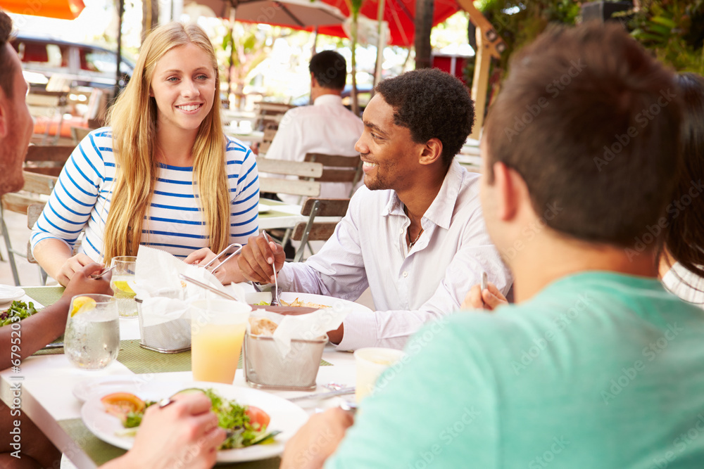 Group Of Friends Enjoying Lunch In Outdoor Restaurant Group Of Friends Enjoying Lunch In Outdoor Restaurant