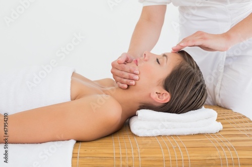 Attractive woman receiving head massage at spa center