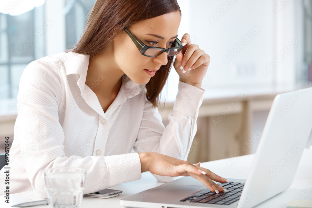 Portrait of smiling Business Woman with a laptop at the Office Portrait of smiling Business Woman with a laptop at the Office