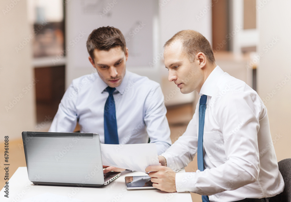 two businessmen having discussion in office two businessmen having discussion in office