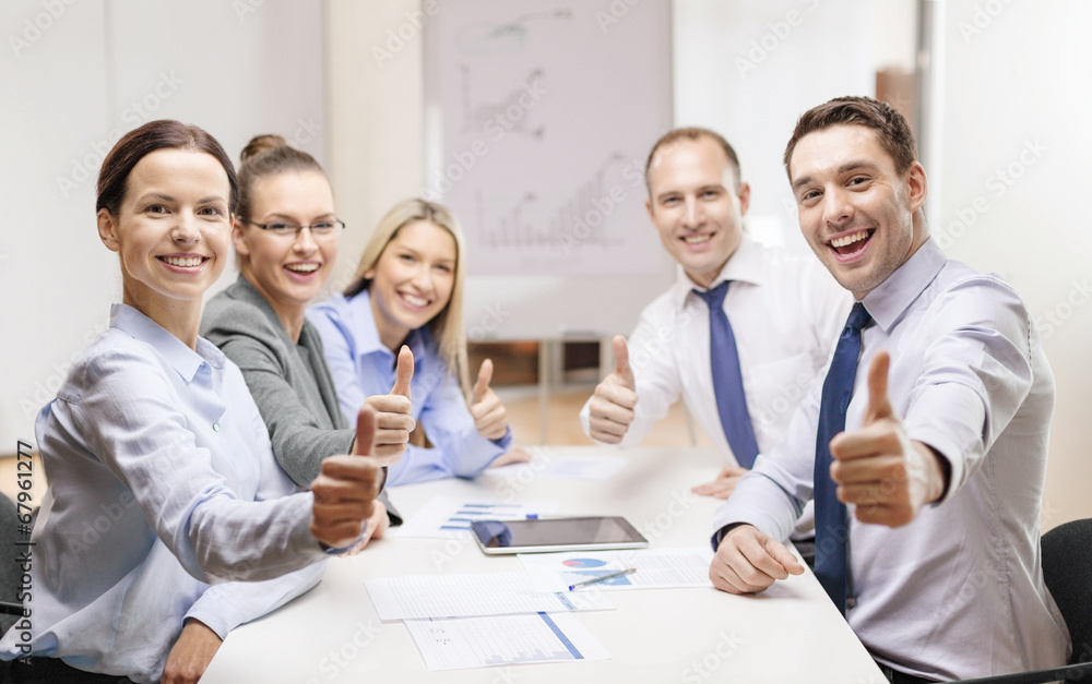 business team showing thumbs up in office business team showing thumbs up in office