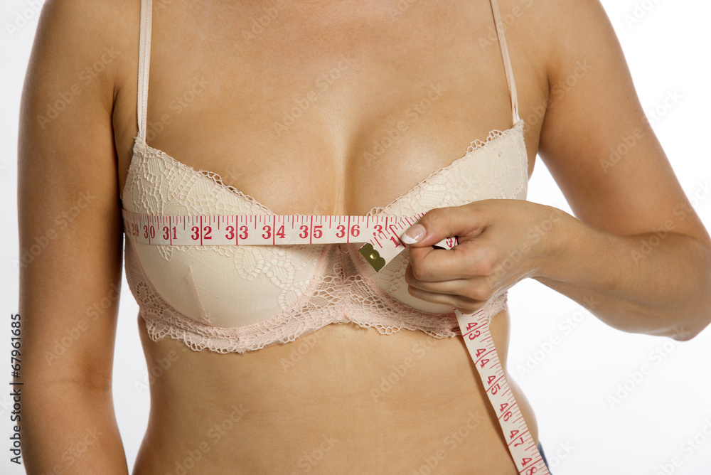 Woman using a tape measure to make bust measurement in inches