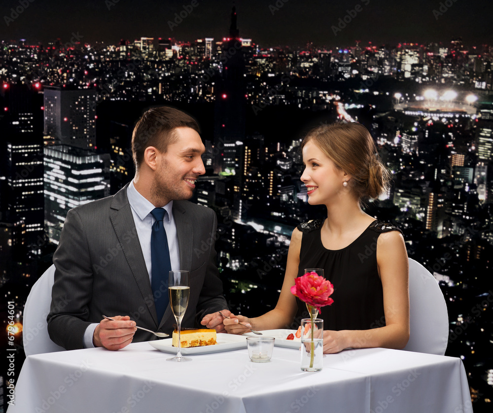 smiling couple eating dessert at restaurant smiling couple eating dessert at restaurant
