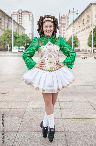 Young woman in irish dance dress posing photo