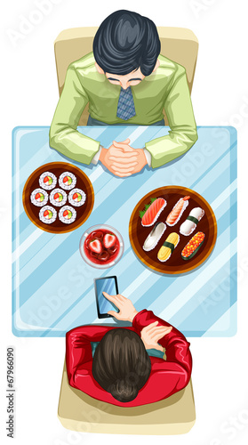 A topview of two people eating sushi