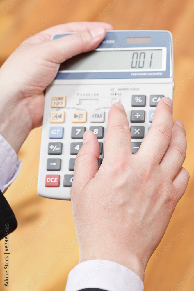 above view of calculator in male hands above view of calculator in male hands
