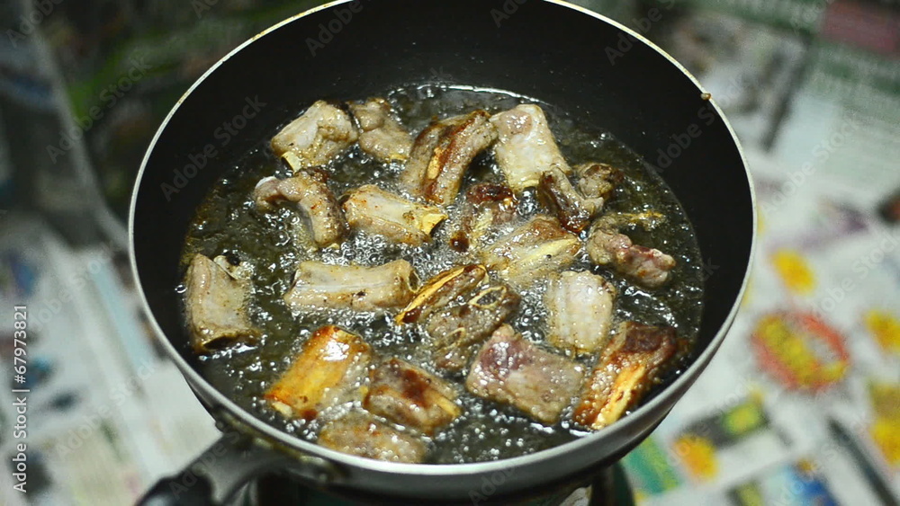 Closeup of fried pork chops in the frying pan on the stove Closeup of fried pork chops in the frying pan on the stove