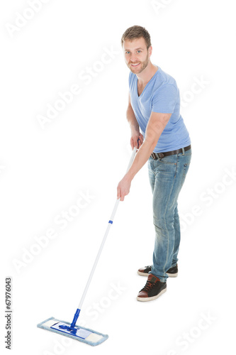 Portrait Of Happy Man Holding Mop