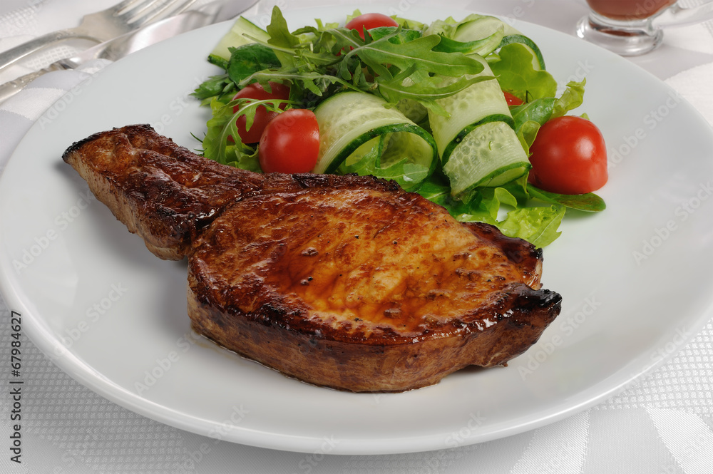 Grilled steak with vegetables on bone