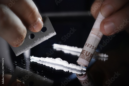 rolled banknote for snorting cocaine line and razor blade