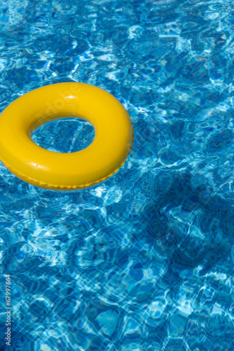 Yellow pool float  pool ring in cool blue refreshing water