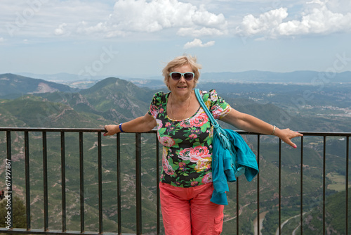 Aged woman on  Llobregat valley background, Montserrat, Cataloni photo