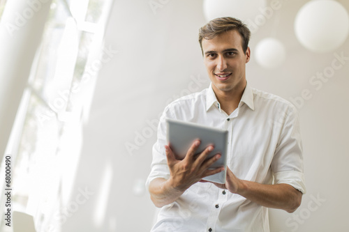 Young man with tablet in the office