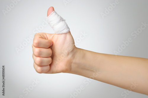 Injured finger with bandage photo