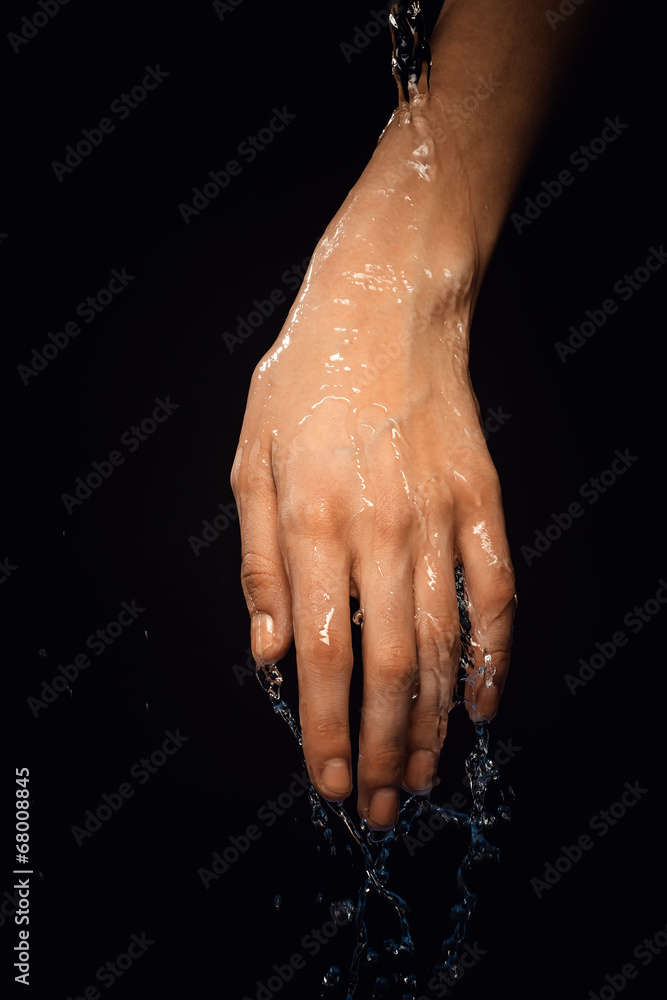 Fototapeta premium From a hand water drips