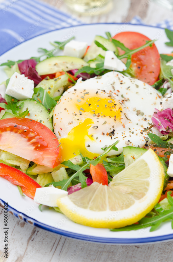 Vegetable salad with poached egg, vertical, closeup Vegetable salad with poached egg, vertical, closeup
