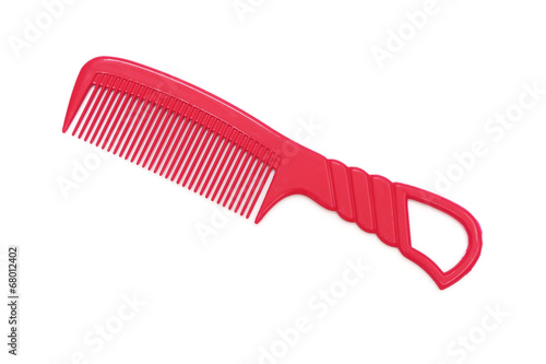 red plastic comb on white background