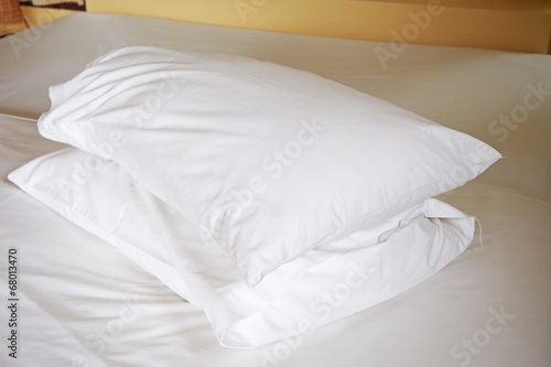 white pillows on bed in bedroom © Ratana21