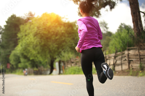 Runner athlete running on road. woman fitness sunrise jogging wo