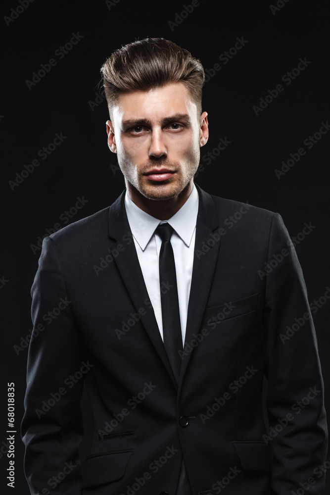 Handsome young man in suit on dark background Handsome young man in suit on dark background