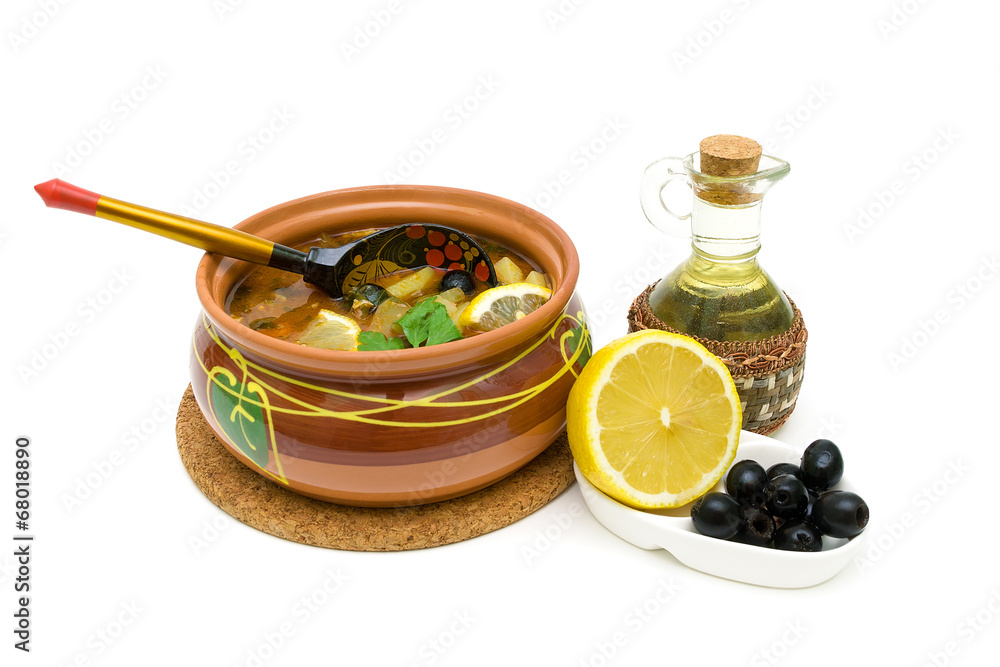 Dish of russian hodgepodge soup in ceramic pot on white backgrou Dish of russian hodgepodge soup in ceramic pot on white backgrou