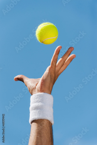 Serving tennis ball. © gstockstudio