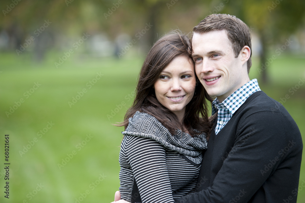 A young and happy couple looking to the left with room for copy space. A young and happy couple looking to the left with room for copy space.