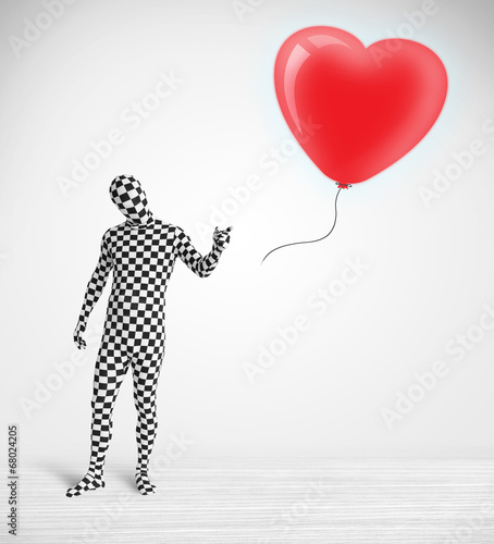 Cute guy in morpsuit body suit looking at a balloon shaped heart photo