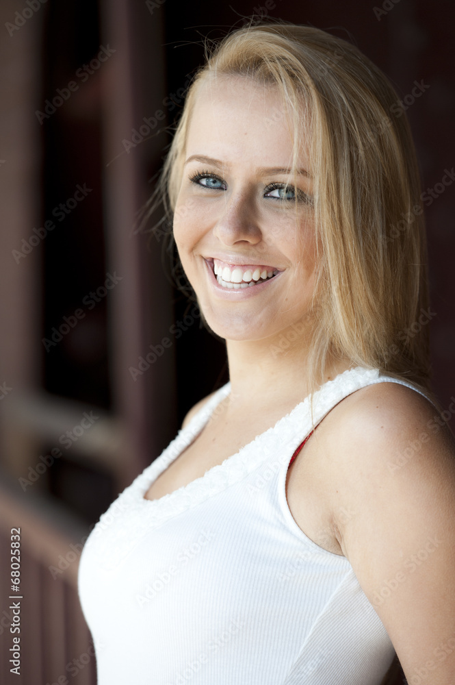 Fototapeta premium A young attractive female blonde model posing outside on a sunny day.