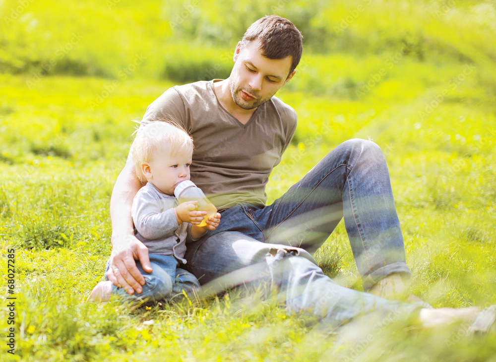 Fototapeta premium Baby drinks from a bottle