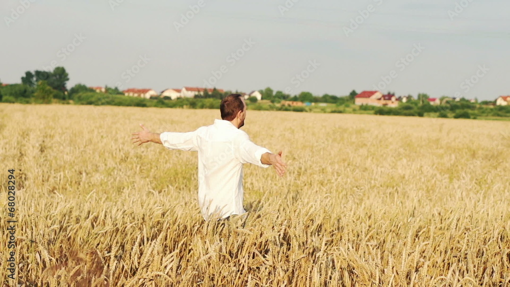 Happy young man running through wheat field Happy young man running through wheat field