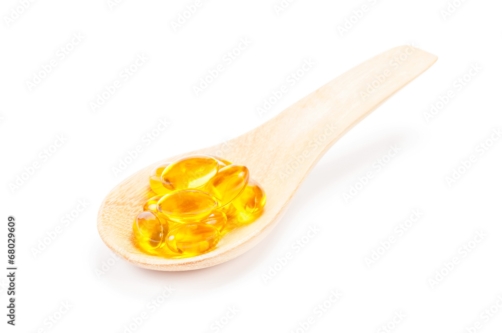 Cod liver oil on wooden spoon Cod liver oil on wooden spoon