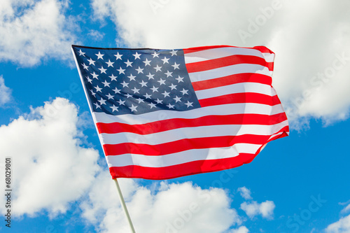 USA flag with white clouds on background