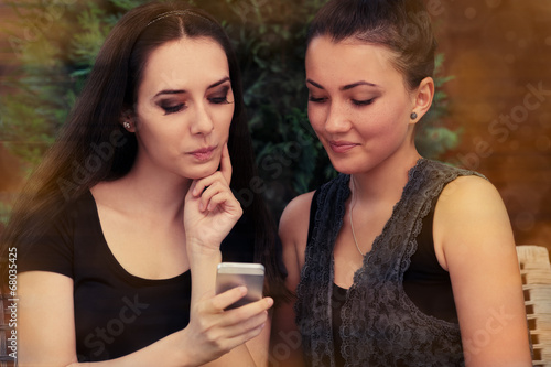 Young Women Looking at Smart Phone Screen