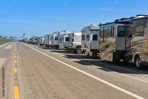 Row of recreational vehicles parked on road