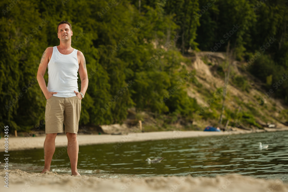 Fashion portrait of handsome man on the beach Fashion portrait of handsome man on the beach