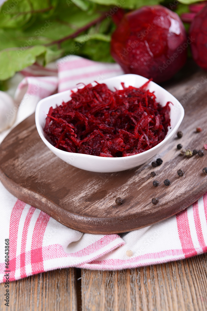 Grated beetroots in bowl on table close-up Grated beetroots in bowl on table close-up