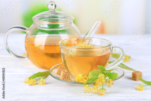 Tasty herbal tea with linden flowers on wooden table