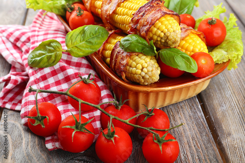 Grilled bacon wrapped corn on table  close-up